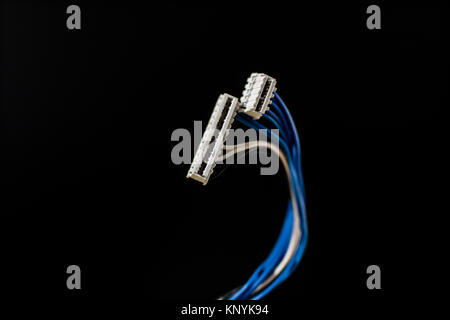 old computer wires. Cables lpt, com1 and com2 for desktop and laptop computers. Wooden table, black background. Stock Photo