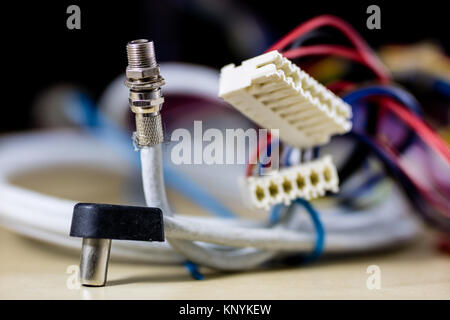 old computer wires. Cables lpt, com1 and com2 for desktop and laptop computers. Wooden table, black background. Stock Photo