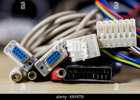 old computer wires. Cables lpt, com1 and com2 for desktop and laptop computers. Wooden table, black background. Stock Photo