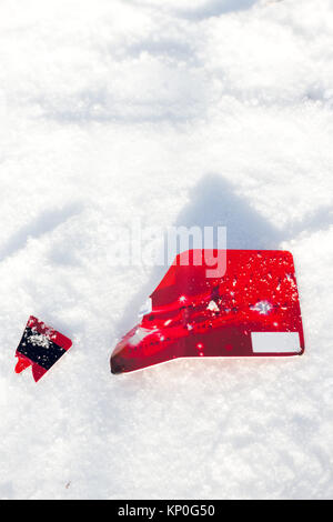 Red broken credit card lies on snow background Stock Photo