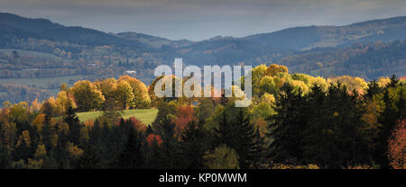 View on Kasperske Hory in Czech Bohemian Forrest during autumn over gentle rolling hills in beatifull colours an stunning light scenery Stock Photo