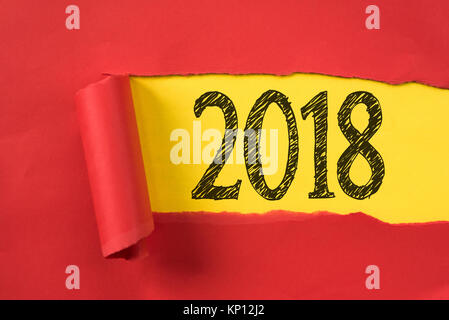 Torn piece of red paper uncovering 2018 underneath. new year concept Stock Photo