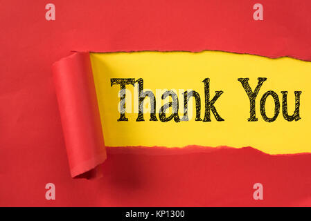 red torn paper revealing THANK YOU word on yellow paper. Thank you concept Stock Photo