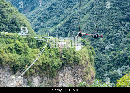 Cascades route, Banos, Ecuador - December 8, 2017: Tourists gliding on the zip line trip against the canyon Stock Photo