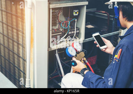 Technician is checking air conditioner Stock Photo