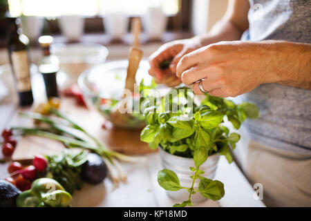 Unrecognizable young man cooking. Stock Photo