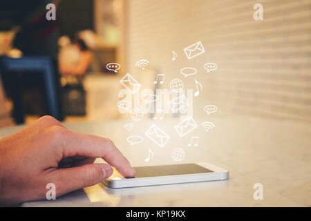 Woman Using smart phone emitting holographic image of social media Stock Photo