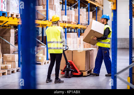Young workers in a warehouse. Stock Photo