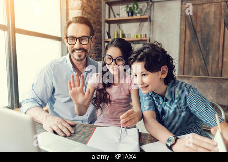 Happy smart girl waving her hand Stock Photo