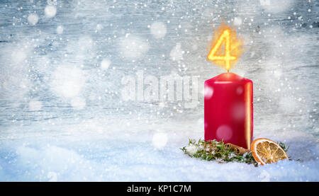 4th Advent candle with snow Stock Photo