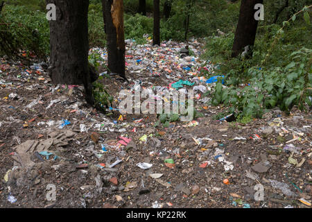 Piles of plastic rubbish and other garbage thrown down bank, an all too common sight around Mcleod Ganj, India Stock Photo