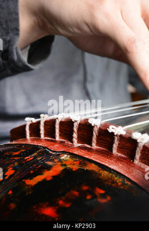 Guqin is a traditional seven string Chinese musical instrument. Stock Photo