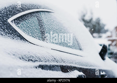 Black car covered in snow, ice on the windows, selective focus Stock Photo