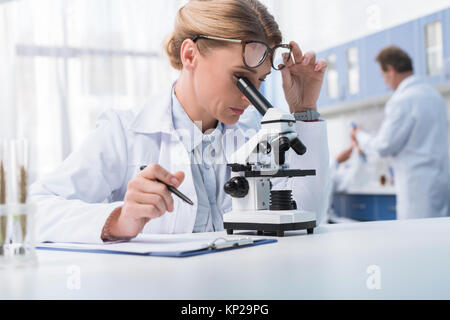 lab technician with microscope Stock Photo