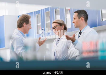 Scientists talking in laboratory Stock Photo