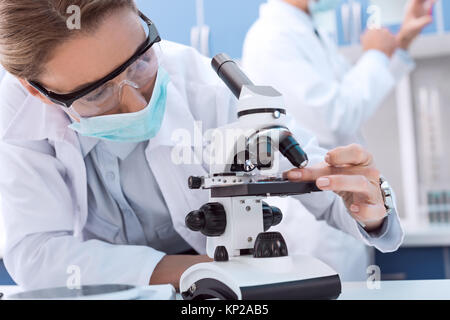 Scientist using microscope Stock Photo
