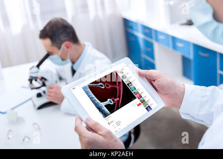 Doctor holding digital tablet Stock Photo