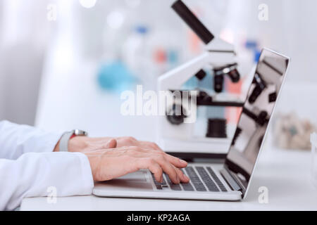 Scientist using laptop Stock Photo