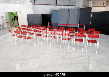 Red chairs in the grunge hall before presentation Stock Photo