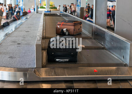 suitcases on the conveyor belt at the airport Stock Photo
