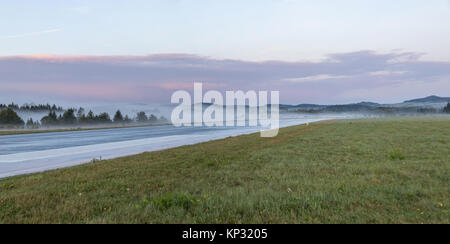 Empty runway at airport during a foggy sunrise. Foggy runway. Stock Photo