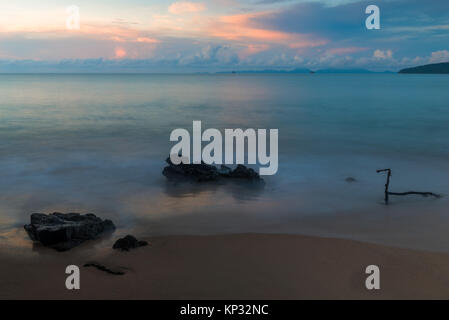 sandy beach and stones on the background of the sea at dawn Stock Photo