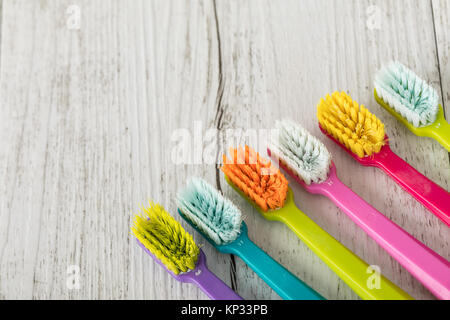 New and used color ultra fine toothbrushes on the table. Dental Industry. various types of toothbrushes. Beautiful smile concept. Whitening. Tooth car Stock Photo