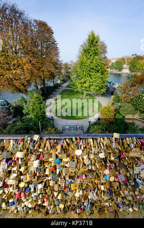 Paris, France. Pont Neuf (bridge) Thousands of Love Locks - padlocks with couples' names - attached to the bridge. Square du Vert-Galant below Stock Photo