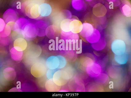 Beautiful bokeh of vivid round lights of changing slowly violet, blue, orange, yellow, pink and purple colors. Horizontal photo of colorful background Stock Photo