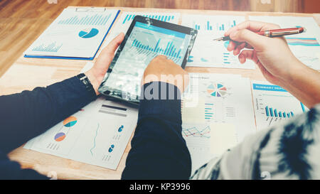 Start up business team meeting working on digital tablet new business project Stock Photo