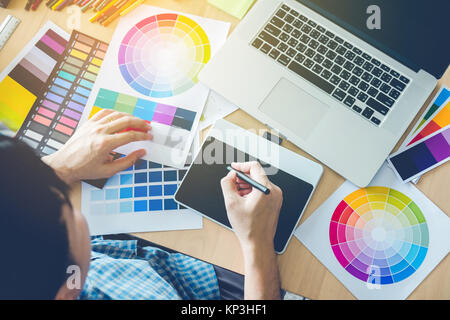 Graphic designer drawing on graphics tablet at workplace Stock Photo