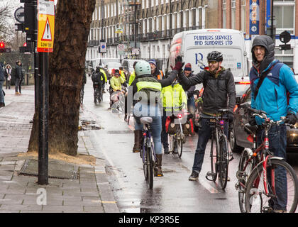 London, England, UK - December 13, 2017: Campaigners make a 'human-protected cycle lane' for cyclists in a call for better infrastructure for walking and cycling on Penton Street, a Transport for London 'Quietway' in Islington, London. Stock Photo