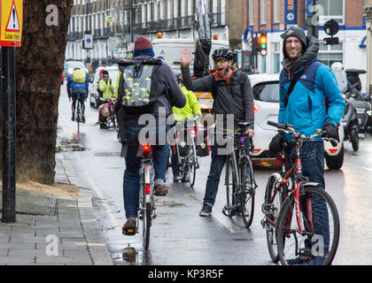 London, England, UK - December 13, 2017: Campaigners make a 'human-protected cycle lane' for cyclists in a call for better infrastructure for walking and cycling on Penton Street, a Transport for London 'Quietway' in Islington, London. Stock Photo