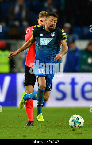 Sinsheim, Germany. 13th Dec, 2017. Stuttgart's goalkeeper Ron-Robert Zieler loses a battle with Hoffenheim's Kerem Demirbay during the German Bundesliga soccer match between 1899 Hoffenheim and VfB Stuttgart in the Rhein-Neckar-Arena in Sinsheim, Germany, 13 December 2017. Hoffenheim won 1-0. Credit: Uwe Anspach/dpa/Alamy Live News Stock Photo