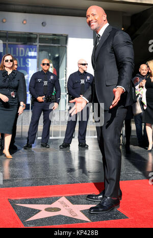 Los Angeles, USA. 13th Dec, 2017. Dwayne Johnson poses for photos at his Hollywood Walk of Fame Star ceremony in Los Angeles, the United States, Dec. 13, 2017. Dwayne Johnson was honored with a star on the Hollywood Walk of Fame on Monday. Credit: Li Ying/Xinhua/Alamy Live News Stock Photo
