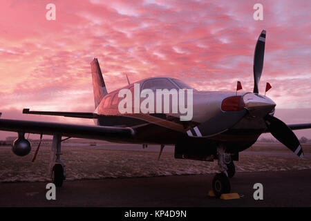 Small private single-engine piston aircraft on runway, Small Propeller plane. Piston aircraft at the airport beautifully colored during the gold hour  Stock Photo