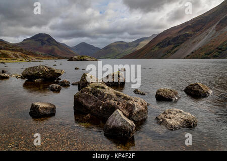 Wastwater looking towards Great Gable with stones in water Stock Photo