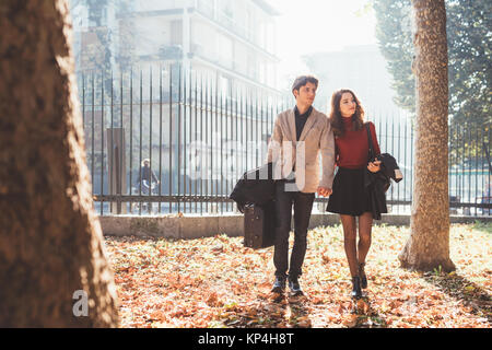 Young beautiful couple in love chatting walking outdoor in the city, having fun - first date,  romantic, love concept Stock Photo