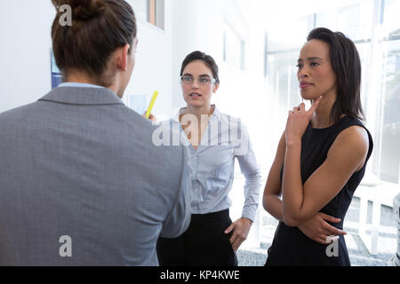 Group of executive discussing over documents in the office Stock Photo