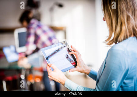 Woman using a digital tablet. Stock Photo