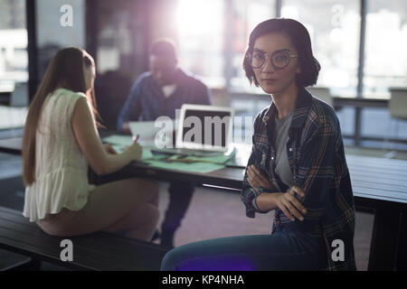 Portrait of female executive sitting in office Stock Photo
