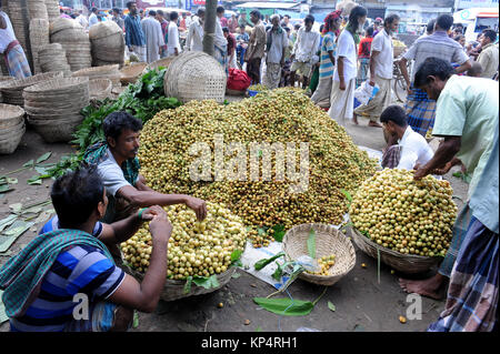 NARSINGDI, BANGLADESH - JUNE 10, 2016: Bangladeshi farmers sell Burmese grape at a market in Narsingdi, near Dhaka. Burmese grape or Lotkon in Bangla  Stock Photo