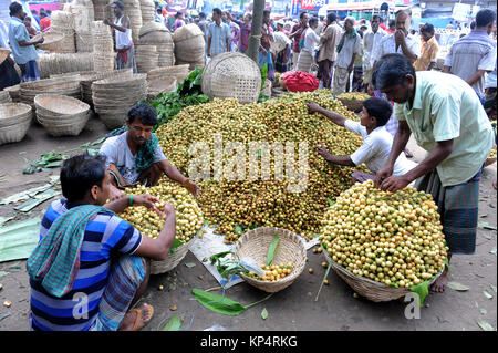 NARSINGDI, BANGLADESH - JUNE 10, 2016: Bangladeshi farmers sell Burmese grape at a market in Narsingdi, near Dhaka. Burmese grape or Lotkon in Bangla  Stock Photo