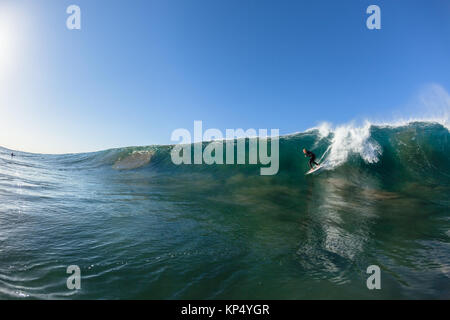 Surfing surfer dropping down vertical ocean wave swimming water photo. Stock Photo