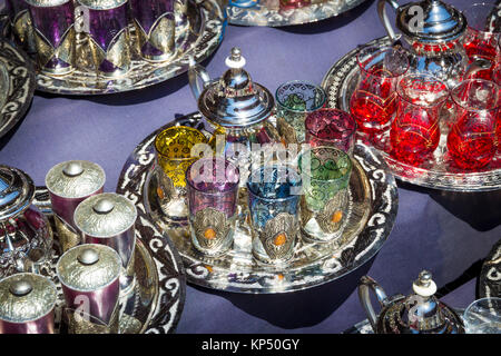 Traditional tea pots with tea glasses on a tray sold in the souks of Marrakesh, Morocco