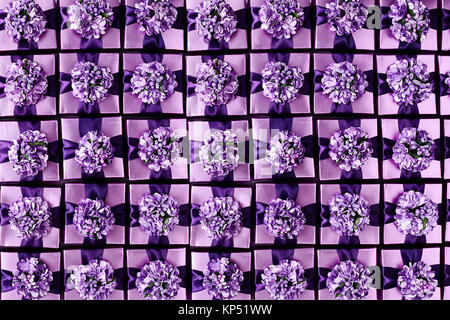 Flat lay full frame background of violet color gift boxes with pretty bows. Stock Photo