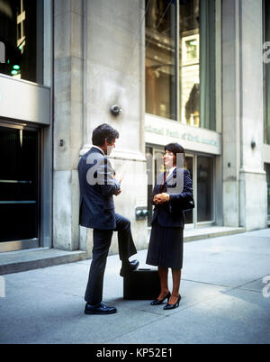 May 1982,New York,businessman and businesswoman chatting,Wall street,financial district,lower Manhattan,New york City,NY,NYC,USA, Stock Photo