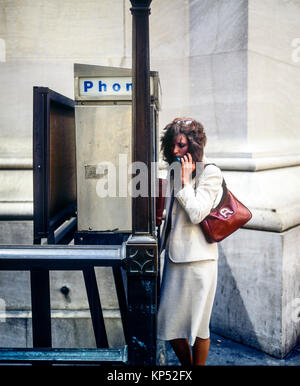 May 1982,New York,businesswoman telephone booth,Wall street,financial district,lower Manhattan,New york City,NY,NYC,USA, Stock Photo