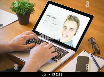 laptop customer serviceconcept. Close-up top view of man with customer support website on laptop. all screen graphics are made up. Stock Photo