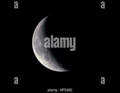 Waning Crescent moon at 30% in the night sky. Stock Photo